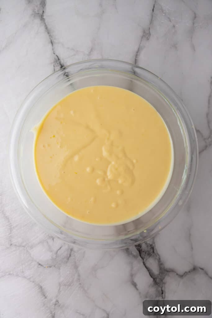 The smooth, creamy lemon pie filling after all ingredients have been thoroughly mixed in a bowl.