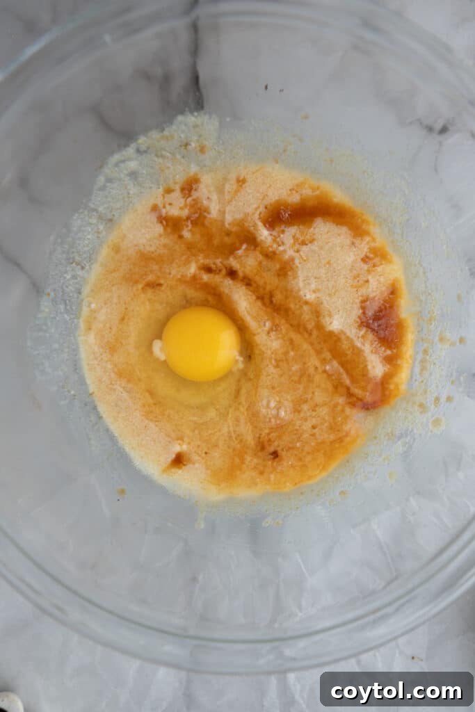 unmixed wet ingredients, butter and sugars, in a bowl for chocolate sugar cookie bars