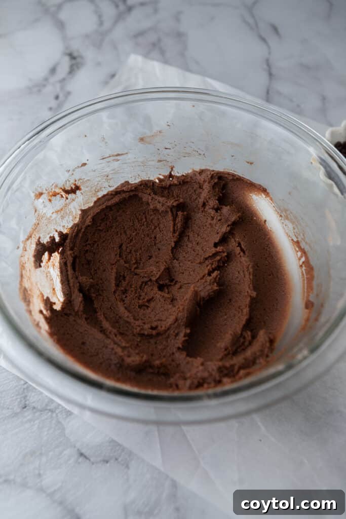 mixed wet ingredients, butter, sugars, egg, and vanilla, in a bowl for chocolate sugar cookie bars