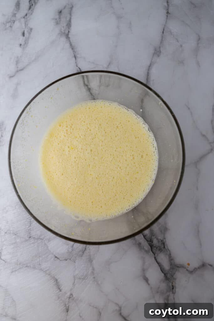 Microwave Lemon Curd: Zesty Perfection in Minutes 6 Wet ingredients (lemon juice, eggs) added to sugar and zest in a bowl.