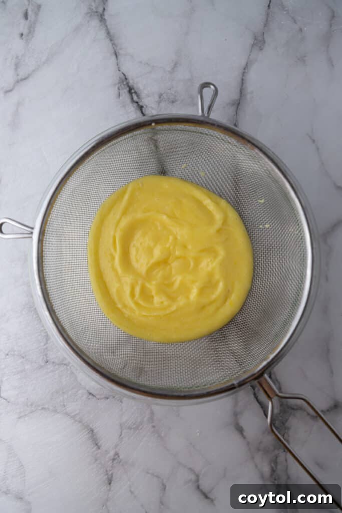 Microwave Lemon Curd: Zesty Perfection in Minutes 8 Straining the finished lemon curd through a fine-mesh sieve.