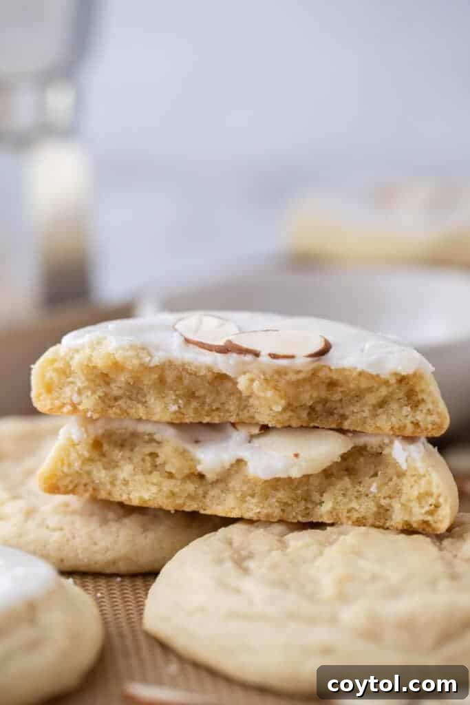 A perfectly stacked pile of soft, iced almond sugar cookies