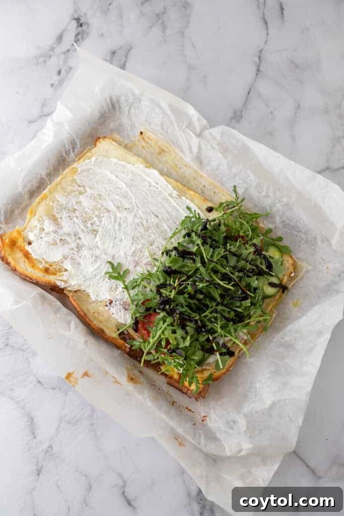The Viral High-Protein Cottage Cheese Wrap Everyone's Raving About 10 Baked cottage cheese wrap on a pan with arugula on top