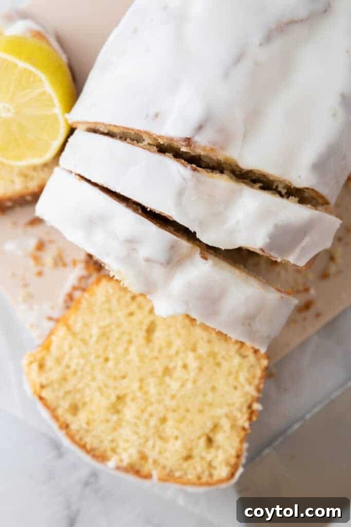 Slice of Whole Lemon Blender Cake on a plate, garnished with zest