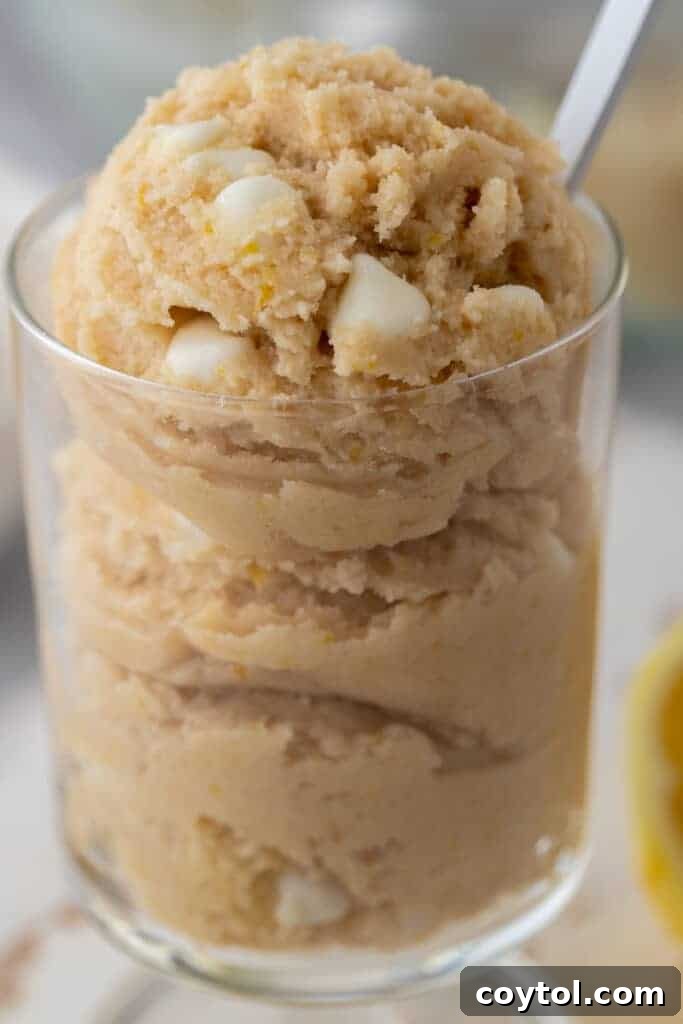 Edible lemon cookie dough served in a cup, showcasing its vibrant yellow color and delightful texture