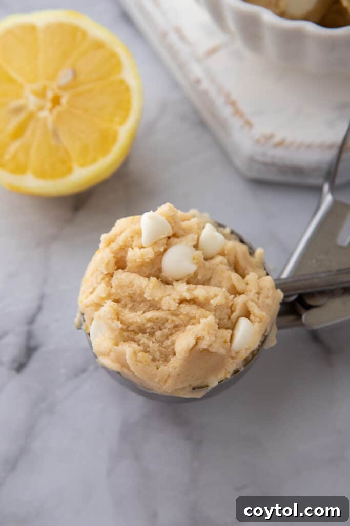 A large scoop filled with edible lemon cookie dough, demonstrating its soft and appealing texture