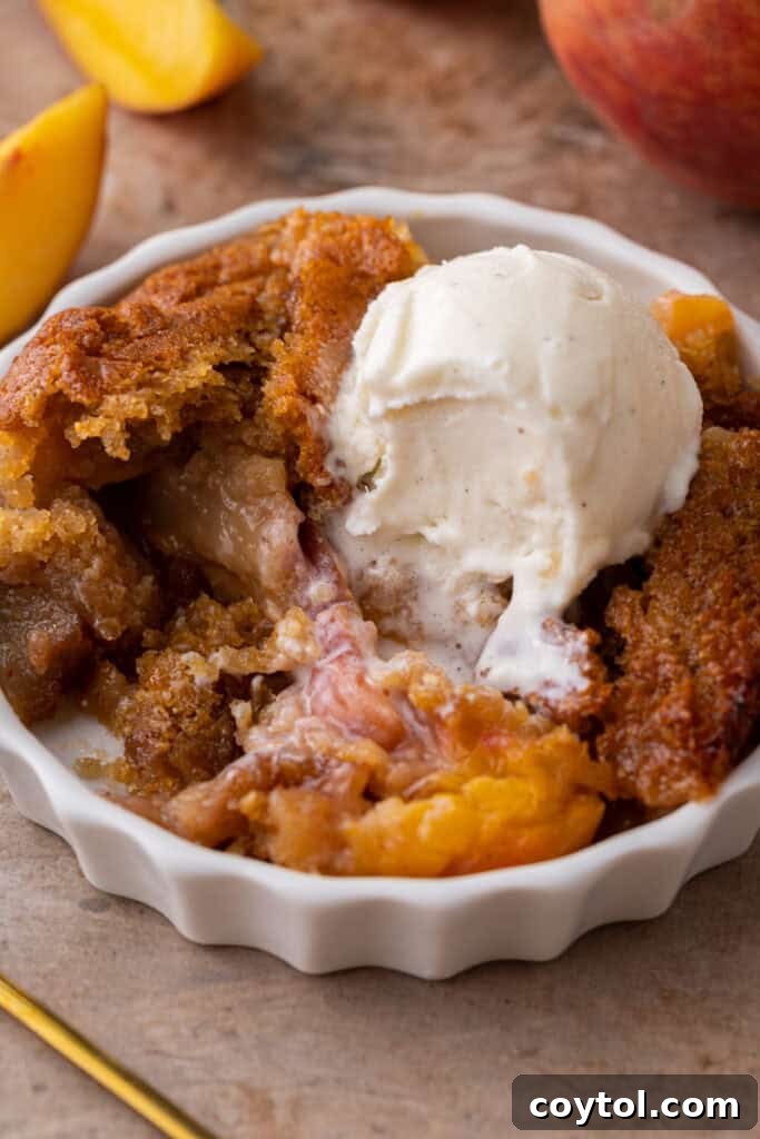Overhead shot of old fashioned peach cobbler with a perfect golden crust
