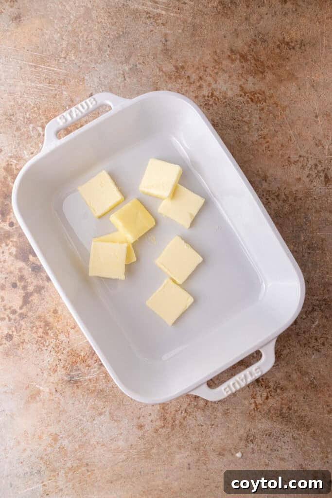 Melted butter in a 9x13 inch baking dish