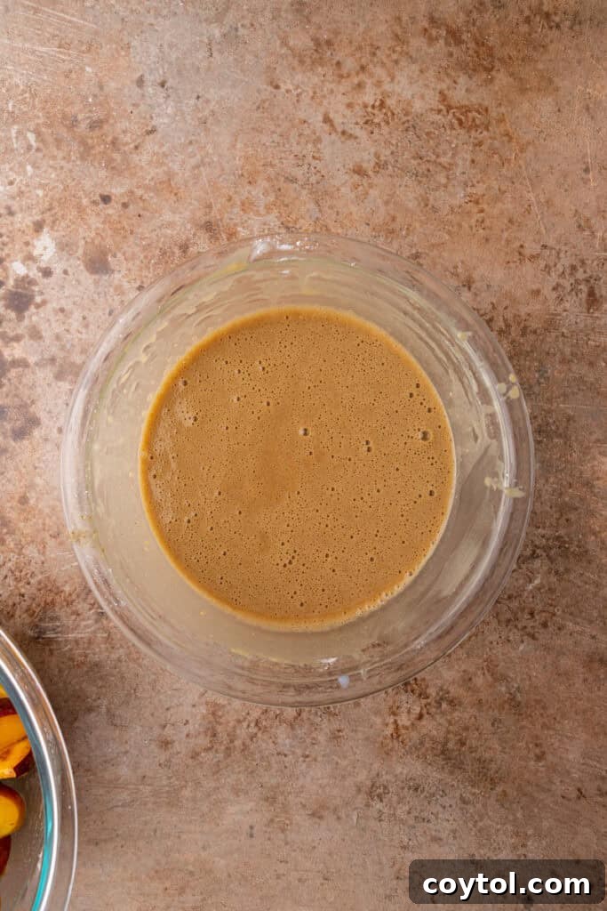 Wet and dry ingredients for the topping mixed into a smooth batter