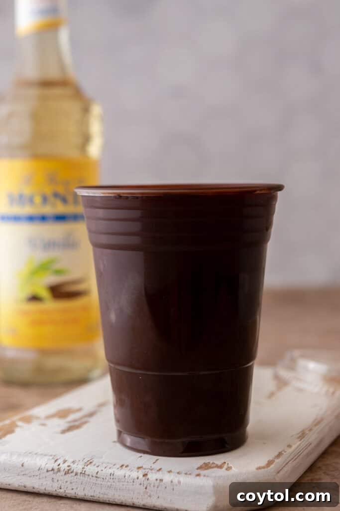 Recreate the Viral TikTok Cracking Iced Latte 6 Plastic cup coated in melted chocolate