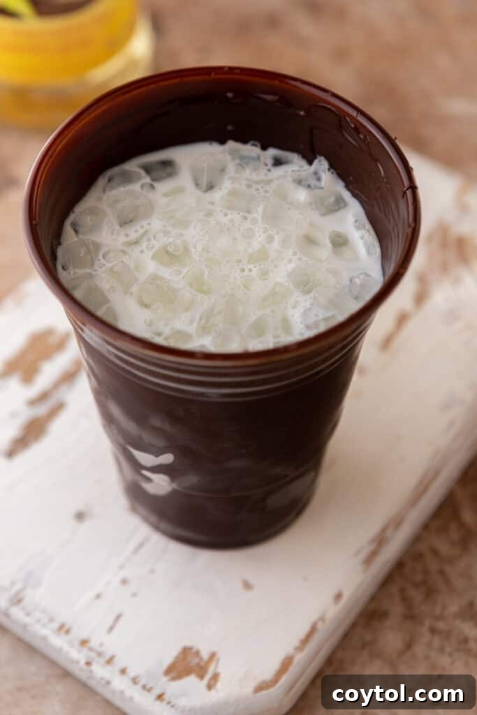 Recreate the Viral TikTok Cracking Iced Latte 7 Milk and ice in chocolate cup