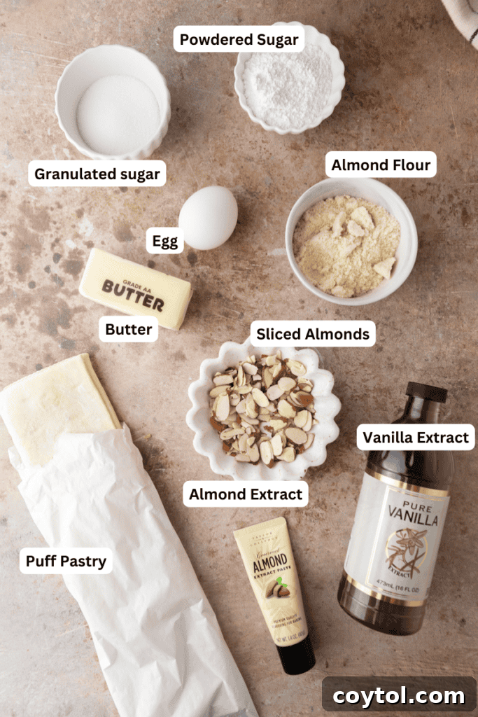 A collection of fresh ingredients laid out, including almond flour, sugar, butter, and puff pastry, for the Braided Almond Croissant Danish recipe.