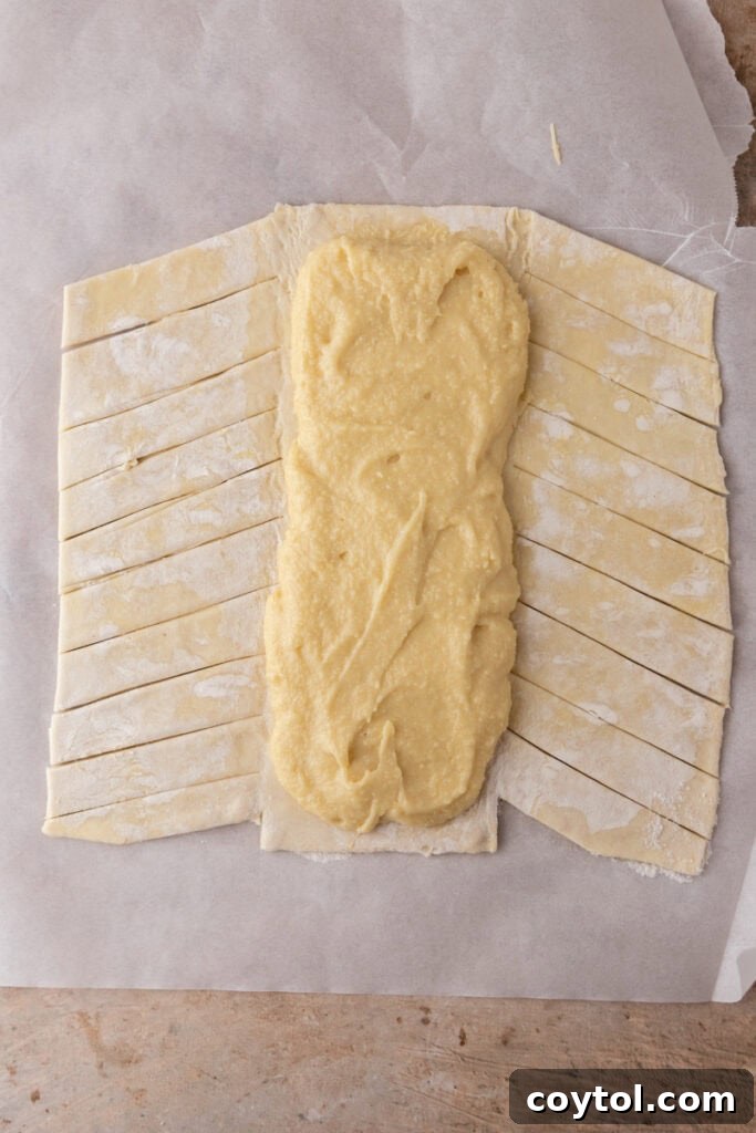 Puff pastry with almond frangipane filling spread down the center