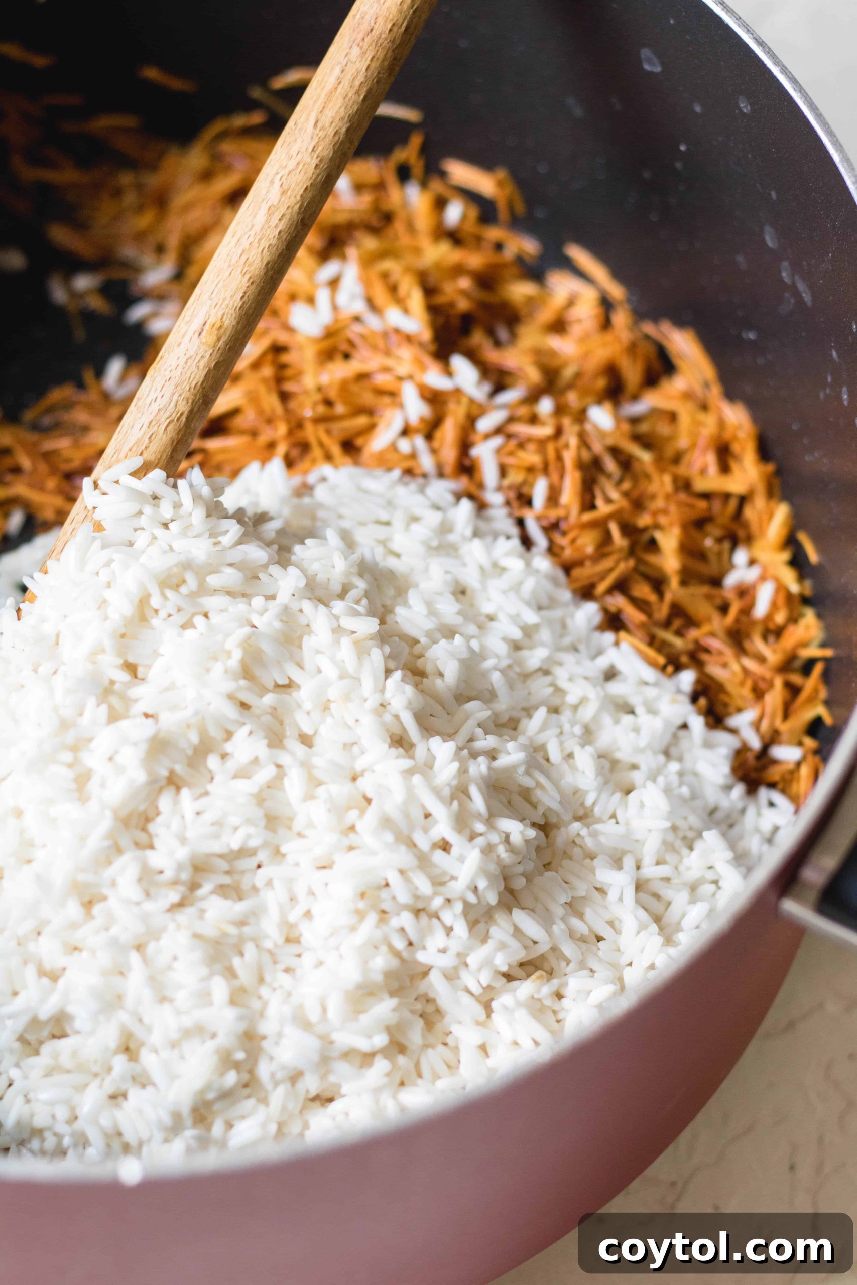 Cooked Lebanese rice pilaf with vermicelli and cinnamon, fluffed and ready to serve, showcasing its light and fluffy texture.