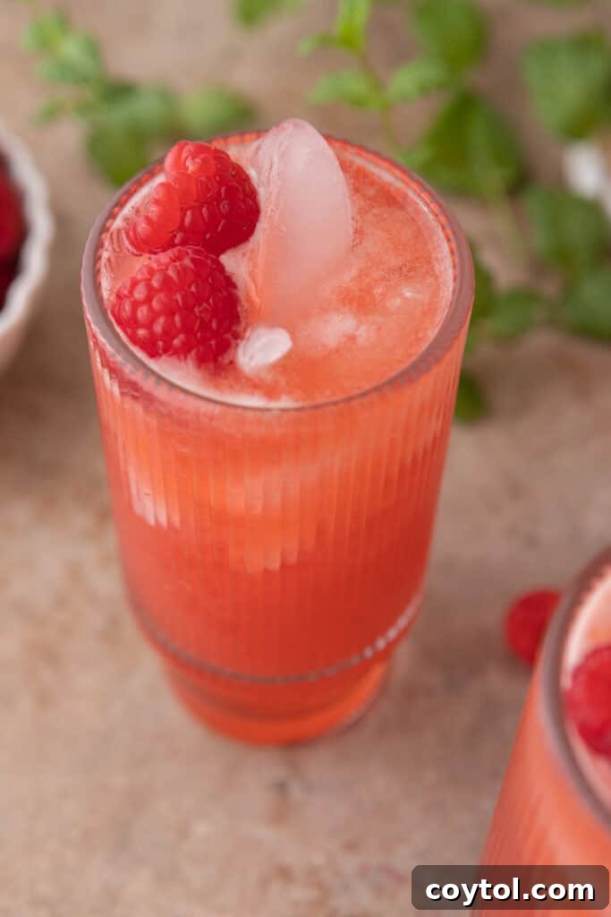 Overhead shot of the raspberry lemonade in a pitcher with glasses