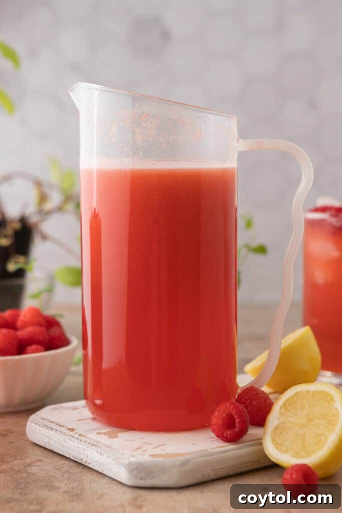 Fully filled pitcher of raspberry lemonade