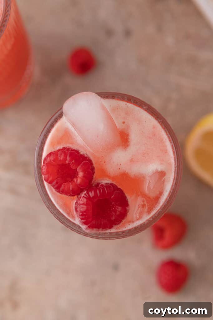 Overhead shot of the raspberry lemonade in a glass with ice