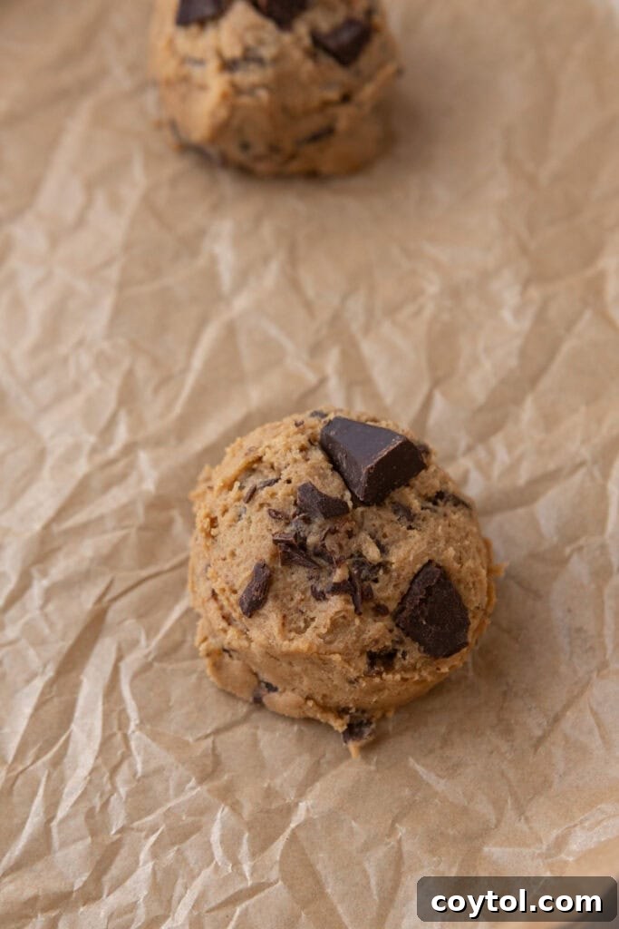 Decadent Soft Chewy Espresso Chocolate Chip Cookies 11 Cookie dough ball on parchment paper