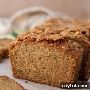 Side shot of the zucchini bread recipe, highlighting its golden crust and delicious appearance.