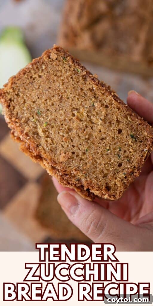 Pinterest pin showing a slice of zucchini bread with a fork, emphasizing its moistness.
