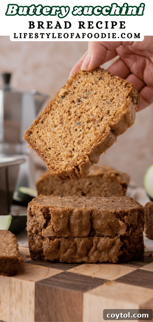 Pinterest pin with a whole zucchini bread loaf and fresh zucchini, highlighting the key ingredient.