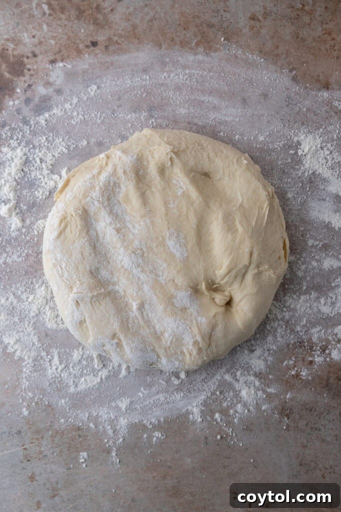 Dough placed on a lightly floured surface, ready to be rolled out into a rectangle.
