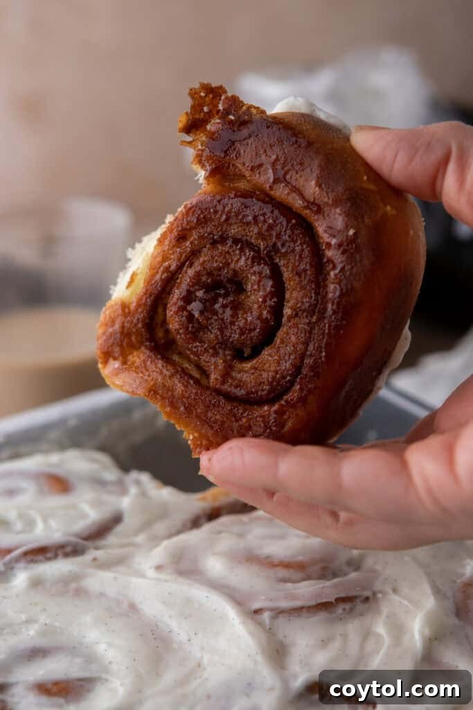 Beautifully frosted Sourdough Discard Cinnamon Rolls, glistening with cream cheese frosting, ready to be enjoyed.