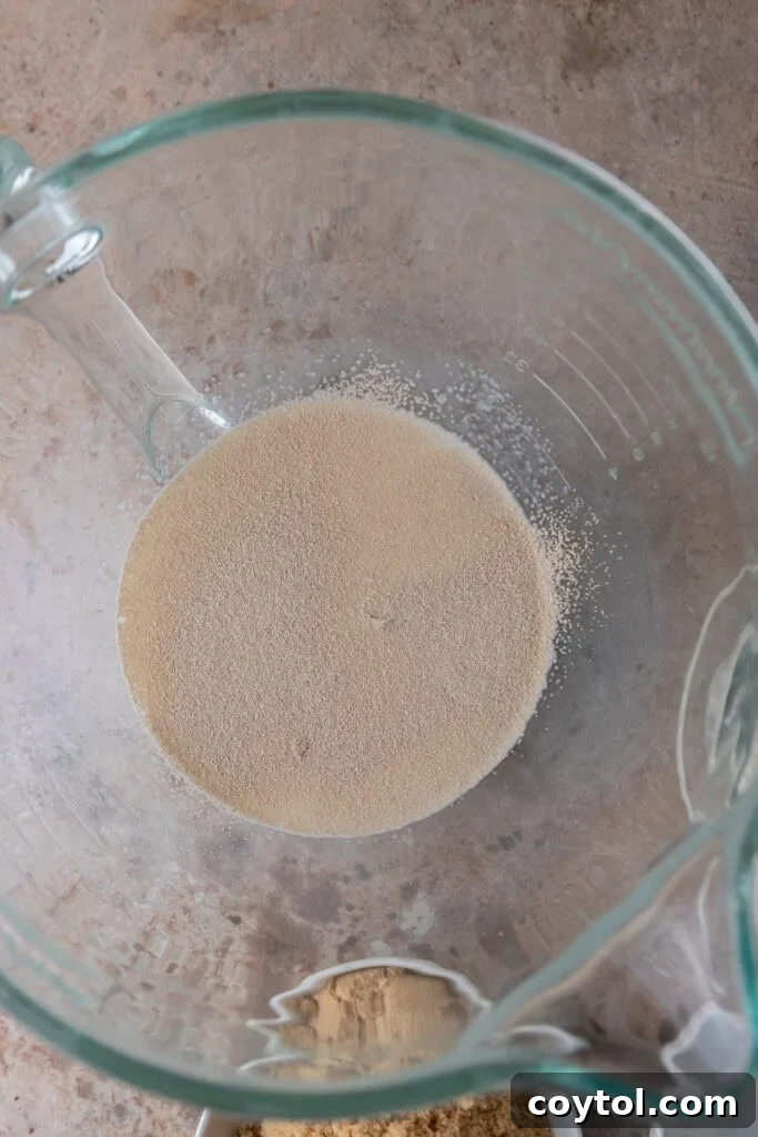 Instant yeast blooming in a bowl with warm milk and a touch of sugar, showing active fermentation.