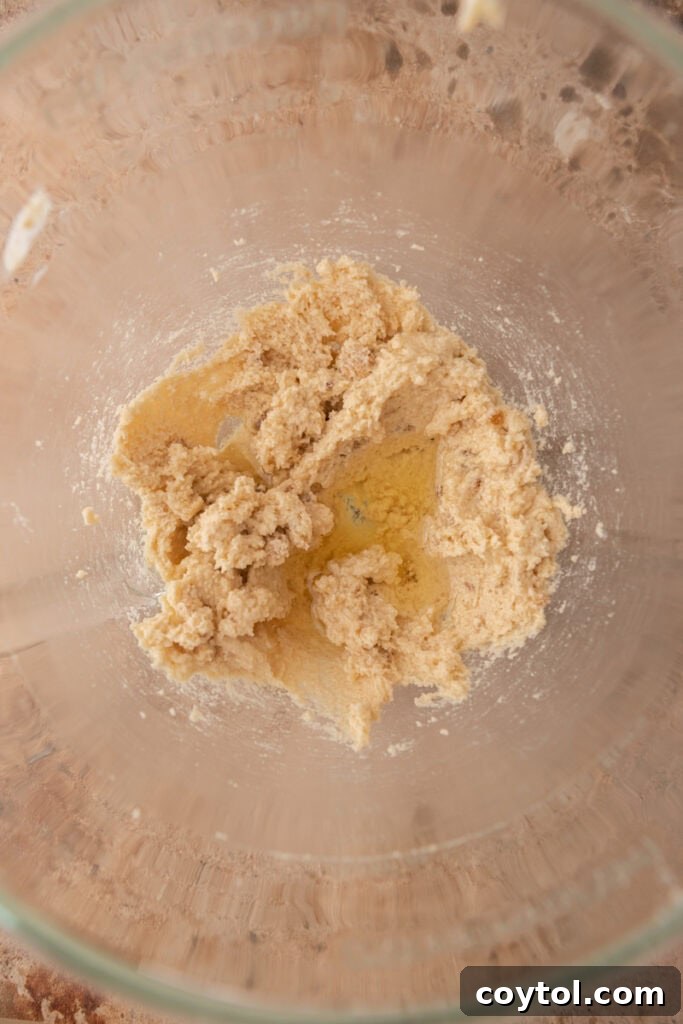 Close-up of butter, granulated sugar, and light brown sugar in a bowl, unmixed and ready for creaming.