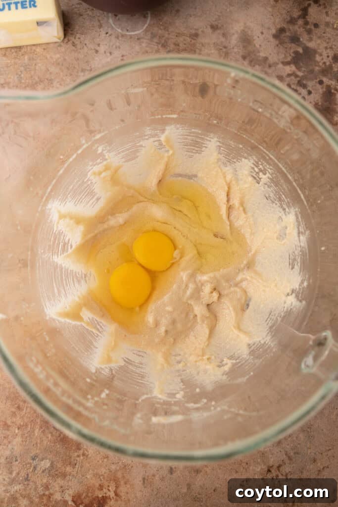 Close-up of wet ingredients including mashed bananas, eggs, and sour cream in a bowl, ready to be combined.