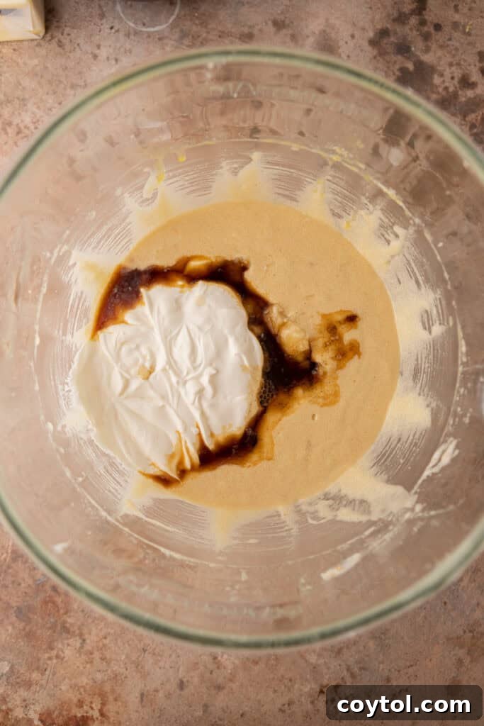 Dry ingredients like flour, cinnamon, baking powder, baking soda, and salt in a bowl, unmixed.