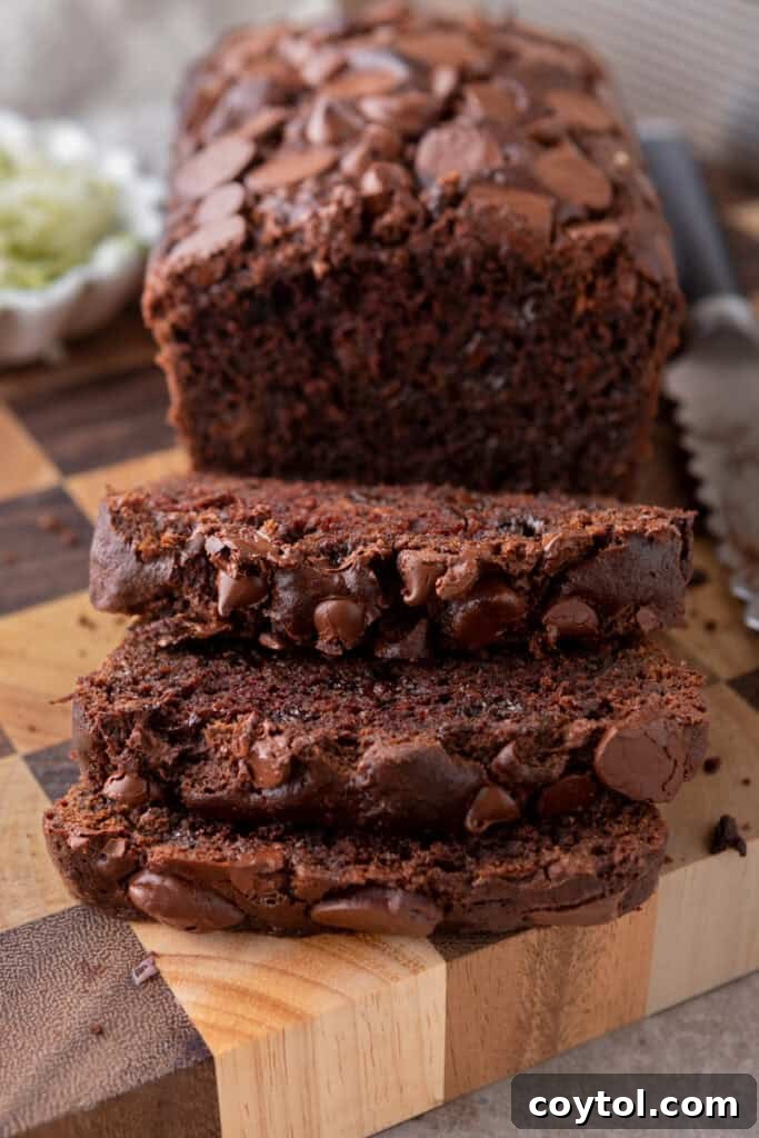 Double Chocolate Zucchini Bread recipe cut in slices, showing its rich, fudgy interior with melted chocolate chunks.