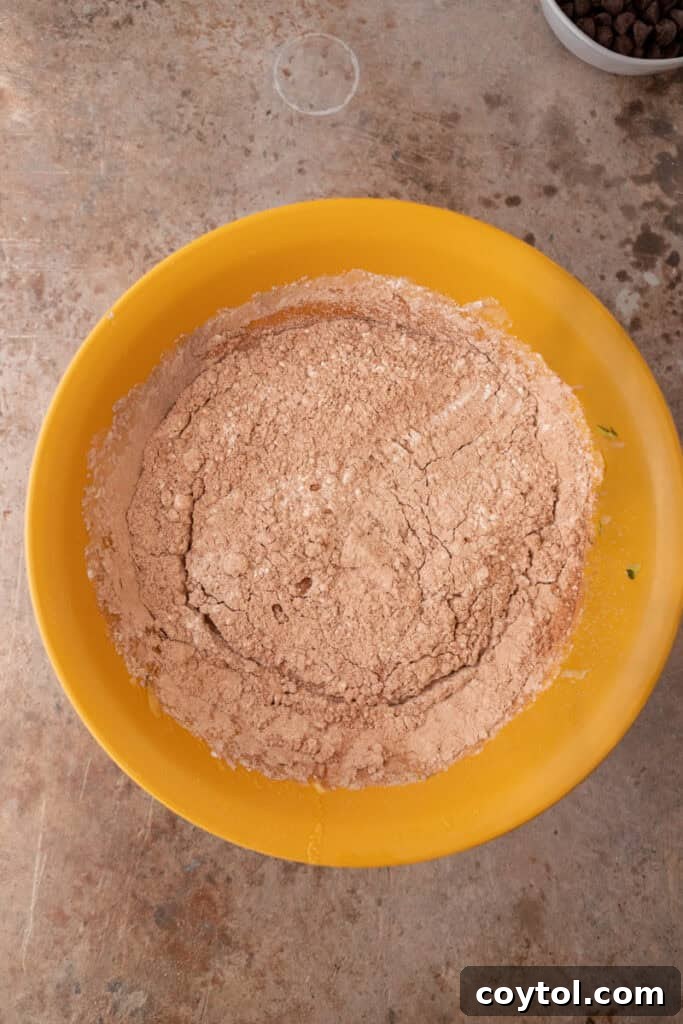 Shredded zucchini mixed into wet ingredients