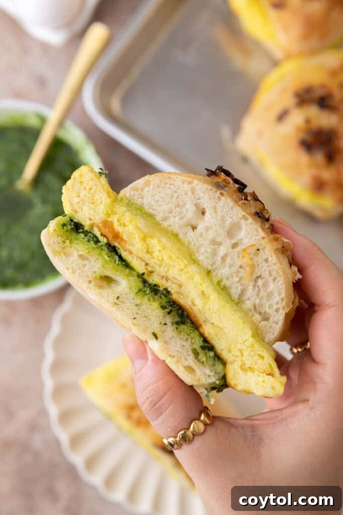 Elevate Your Breakfast Starbucks Style Egg Kale Pesto Mozzarella Sandwich 14 Starbucks Egg Kale Pesto Mozzarella Sandwich recipe being held up by a hand