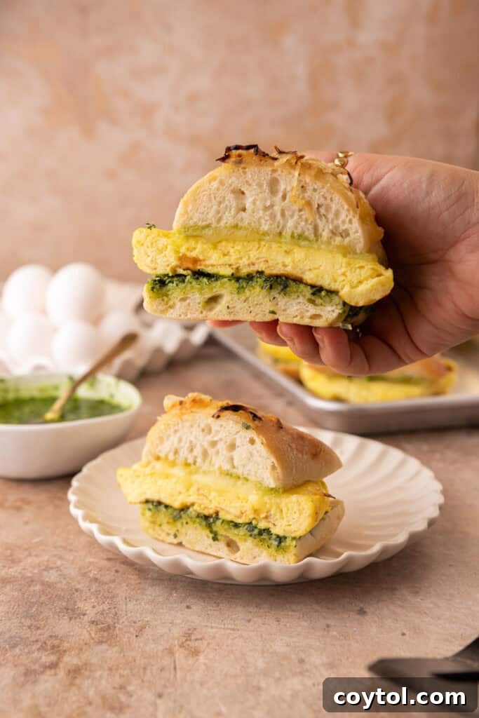 Elevate Your Breakfast Starbucks Style Egg Kale Pesto Mozzarella Sandwich 4 Starbucks Egg Kale Pesto Mozzarella Sandwich recipe being held up by a hand