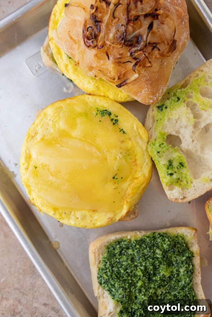 Elevate Your Breakfast Starbucks Style Egg Kale Pesto Mozzarella Sandwich 10 ingredients on a pan ready to be assembled