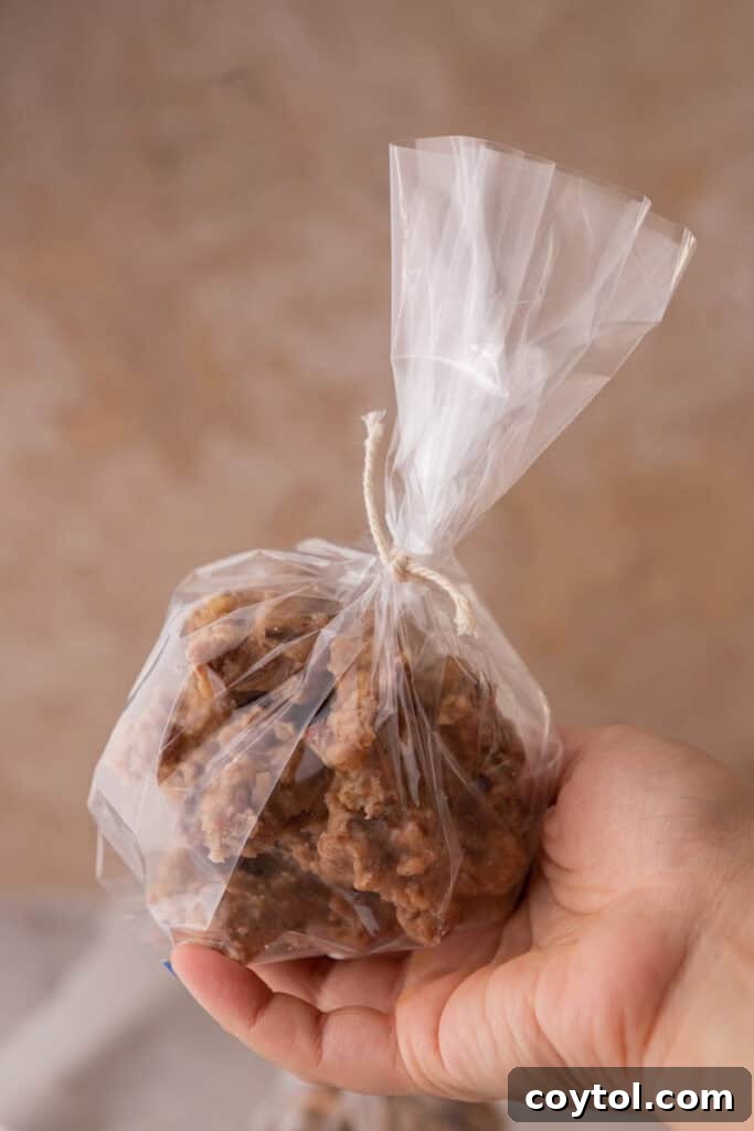 New Orleans pecan pralines recipe wrapped up in a bag being held up by a hand