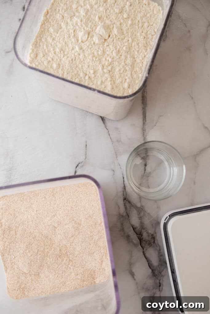 Ingredients for homemade sourdough starter: flour and water in bowls
