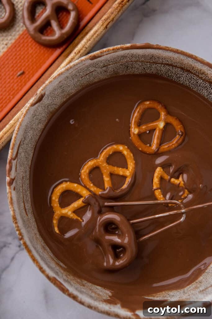Irresistible Chocolate Pretzel Perfection 6 snacks being dipped into melted candy