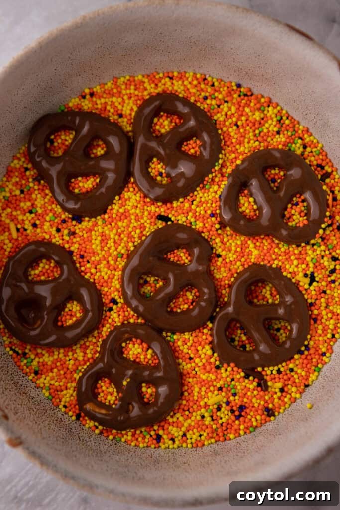 Irresistible Chocolate Pretzel Perfection 7 Chocolate covered pretzels recipe being dipped in sprinkles