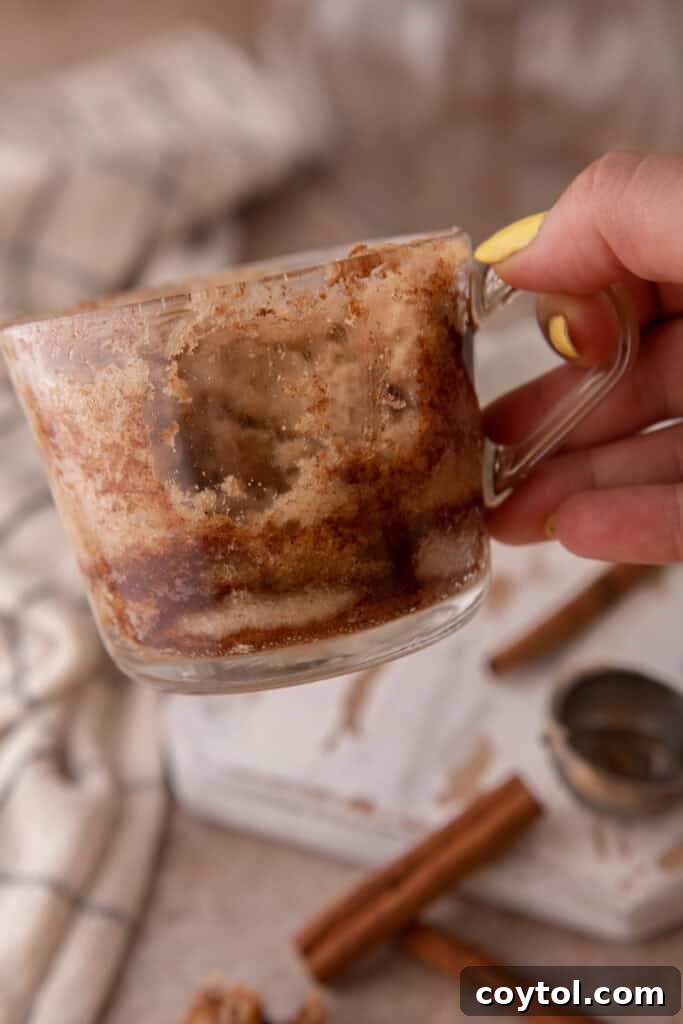 hand holding up an empty cup