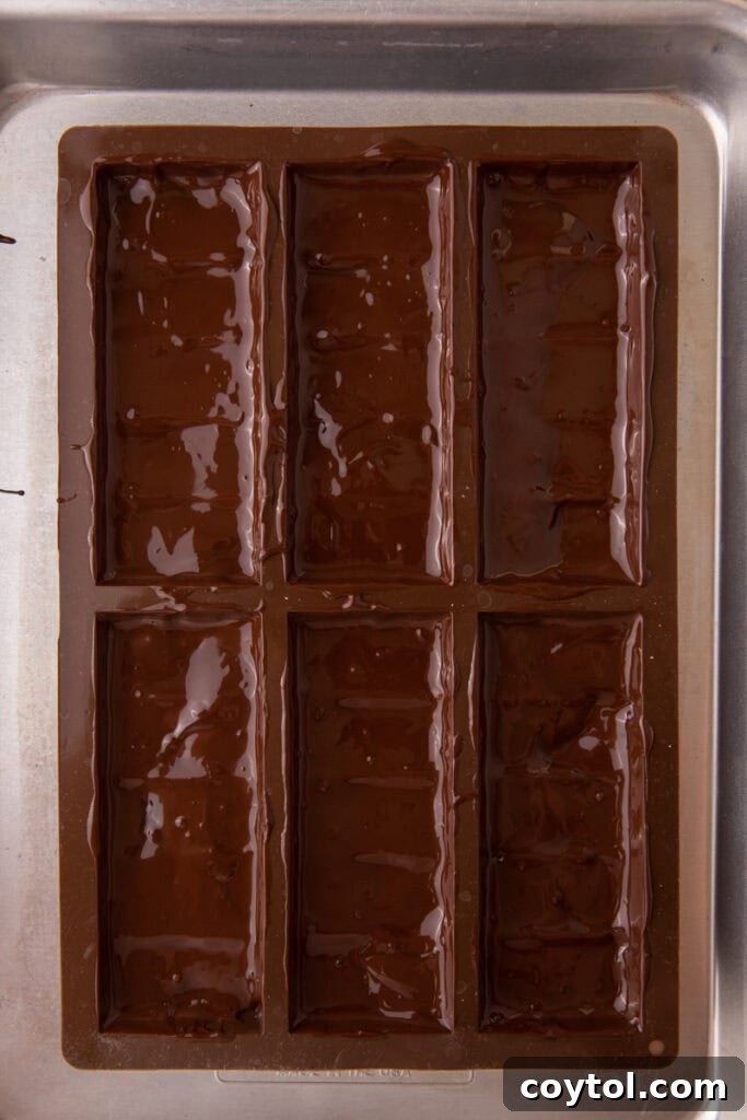 Dubai's Ultimate Pistachio Chocolate Bar 10 Melted chocolate spread in a mold