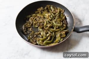 Caramelized bell peppers cooking in a pan