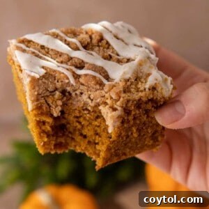 Pumpkin Coffee Cake being held up by a hand