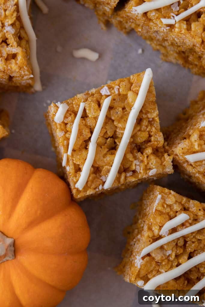 Autumn Pumpkin Rice Krispie Perfection 12 Overhead shot of pumpkin rice krispie treats arranged on a festive platter.