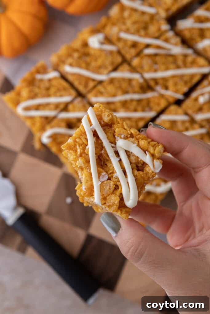 Autumn Pumpkin Rice Krispie Perfection 13 Close-up shot of pumpkin rice krispie treats, showing the rich orange color and texture.