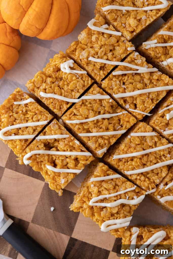 Autumn Pumpkin Rice Krispie Perfection 4 Overhead shot of pumpkin rice krispie treats mixture in a large pot, showing the process of mixing ingredients.