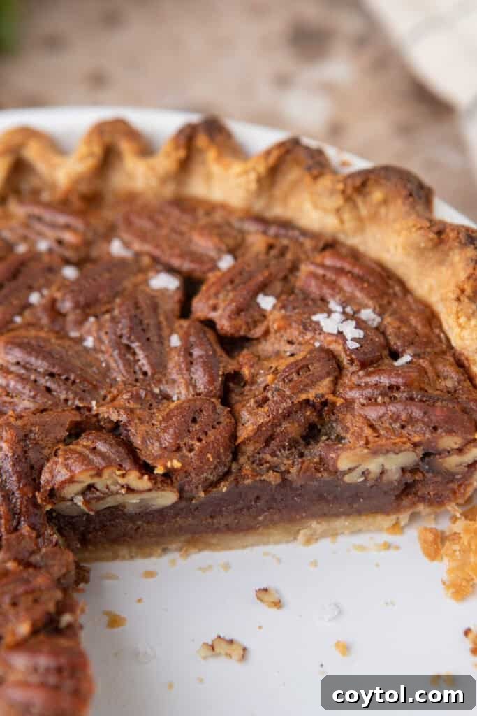 maple pecan pie with a slice taken out