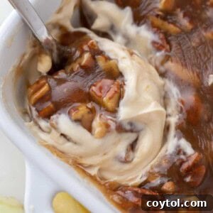 Pecan pie dip ready to be scooped, showcasing the delightful layers.