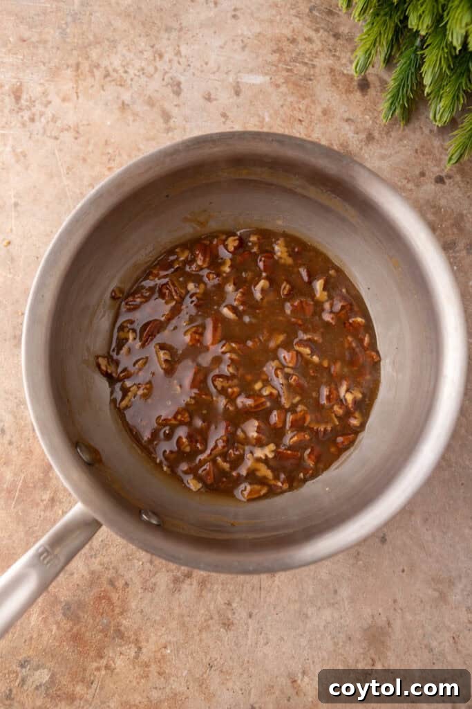 Mixed ingredients for the pecan pie topping simmering in a saucepan.